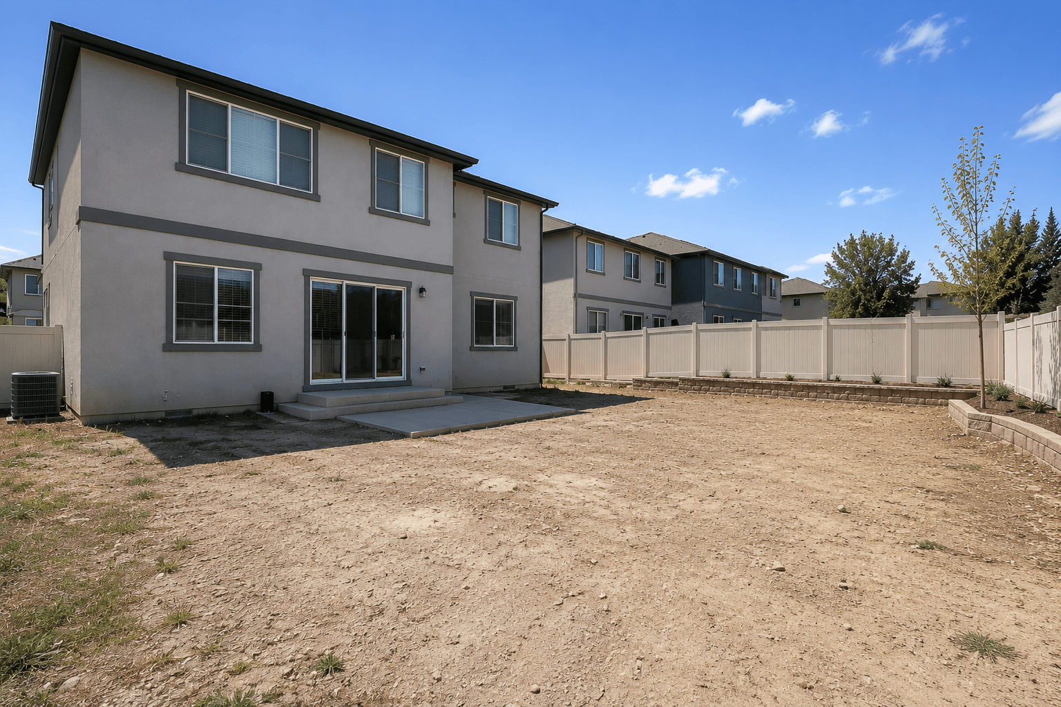 Before — the existing bare-dirt backyard